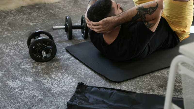 beginner doing best full body workout at home without equipment on yoga mat