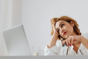 Person sitting quietly and thinking deeply, showing early signs of overthinking and wondering how do I stop negative thoughts before they take over the mind