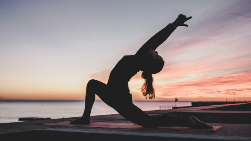 Yoga for Beginners practicing simple yoga pose at home to improve flexibility and reduce stress