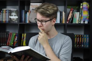 Student concentrating on books and notes, showing the importance of focus for studying and improved learning outcomes.