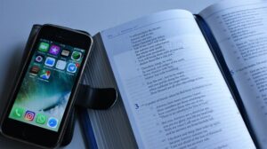 Person distracted by phone while trying to focus on your goal, showing the hidden cost of daily distractions